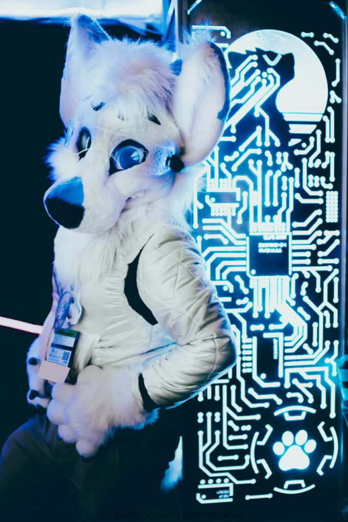 Marks Barks' character is mostly white with blue and black accents. He is pictured with cyberpunk-themed glasses and a cyberpunk-themed background.